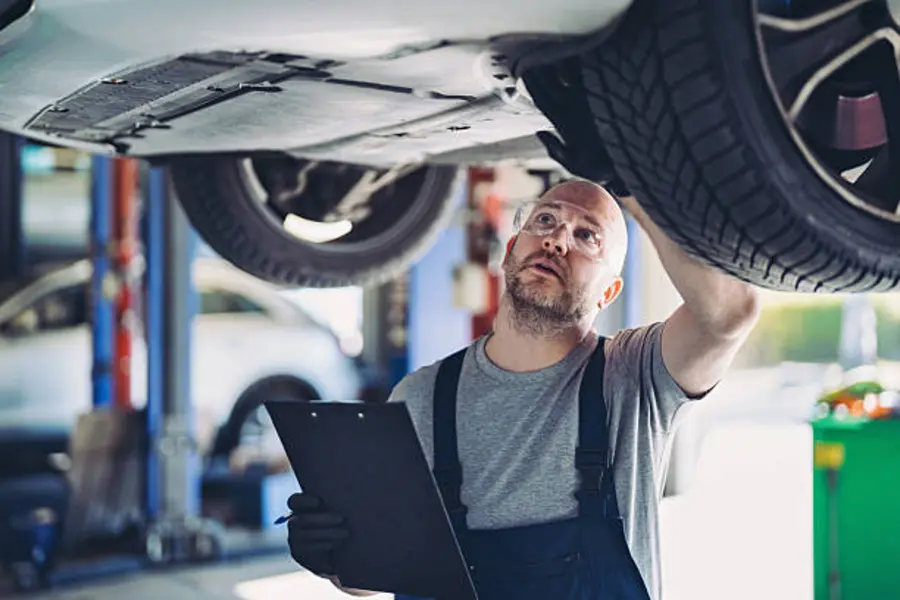 Technician inspecting a vehicle build stage